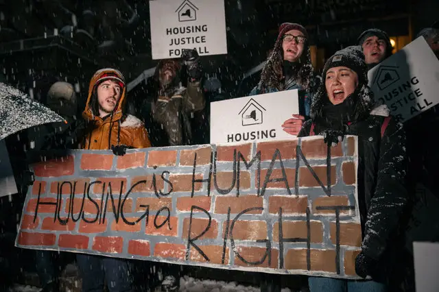 Protesters marched during a snowstorm in November to demand tougher rent protections.